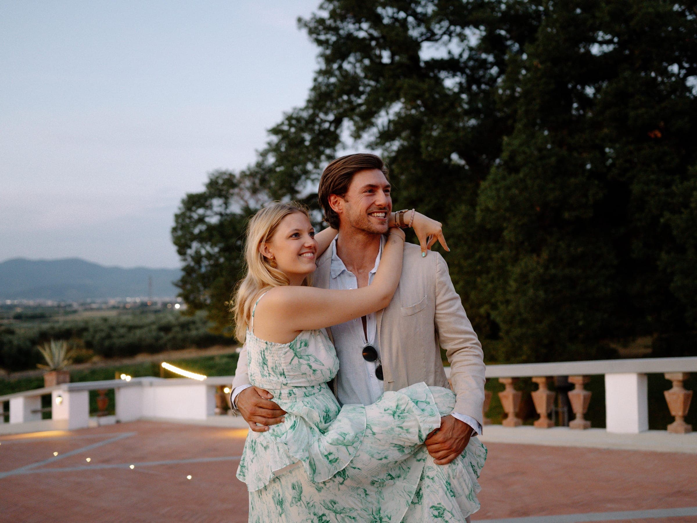 Emilia and Conrad in the garden, laughing, just after the proposal